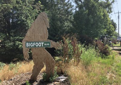 Bigfoot Blvd Street Sign Nebraska Directory Wooden Bigfoot cutout holding a street sign that reads Bigfoot Blvd