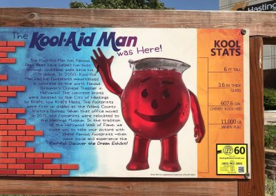 KoolAid Man Was Here Sign Nebraska Directory Sign reading The Kool Aid Man was Here with Kool Aid Man graphic and history of his footprints